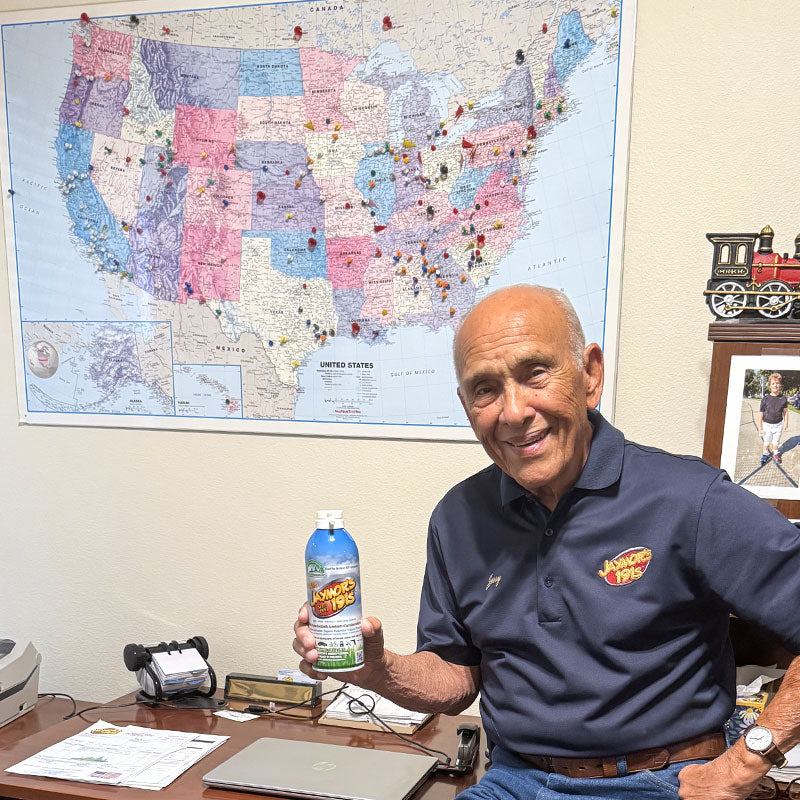 Gerold Moreno, the president and CEO of Jaymor Enterprises, Inc., is holding a can of Jaymor's 191S and sitting on a desk with a map of the United States in the background that shows some of the many places the lubricant is distributed across the country.